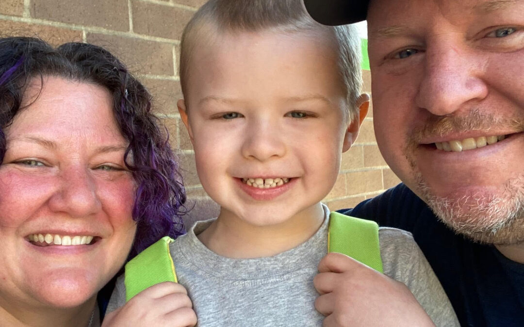 Tristan and his parents smiling