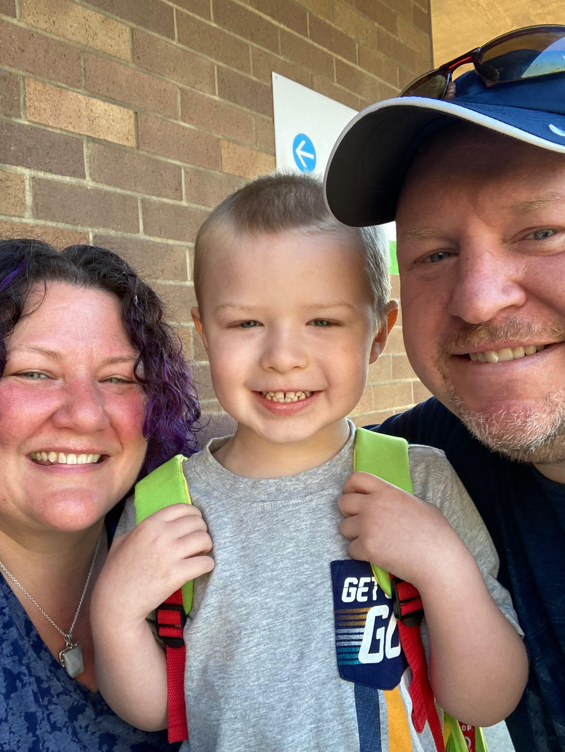 Tristan and his parents smiling